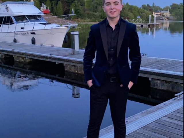 Owen beside boat